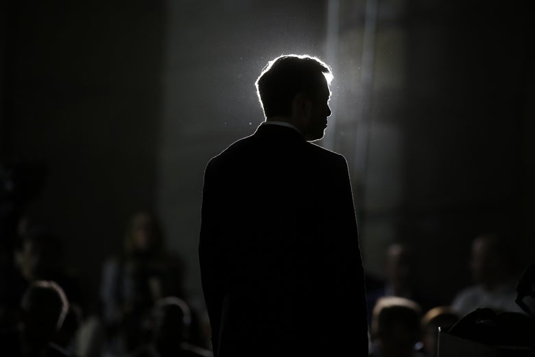 Elon Musk, seen in near-silhouette.